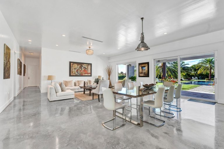 Dining area with sliding glass doors overlooking the pool