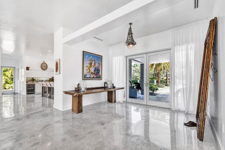 Bright foyer with artwork and doors opening to the garden