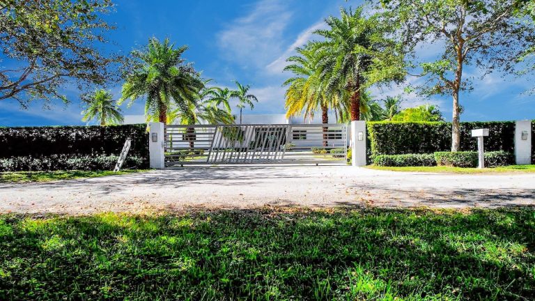 Palm-lined private front gate to the Miami estate