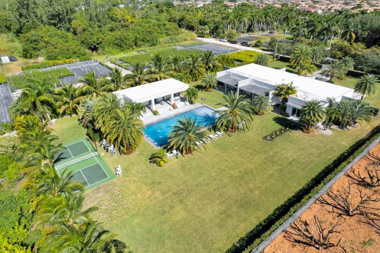 Aerial view of the residence, pool, court, and expansive grounds