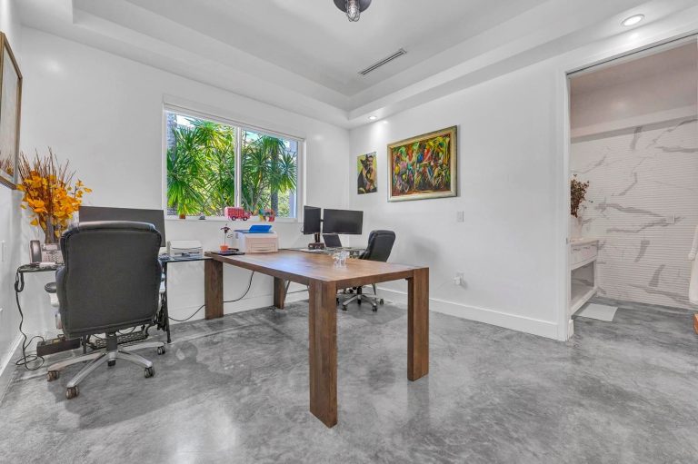 Private home office with garden view and contemporary artwork