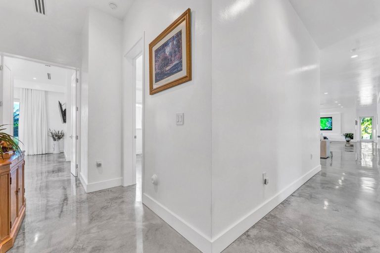 Bright interior hallway with polished floors and curated artwork