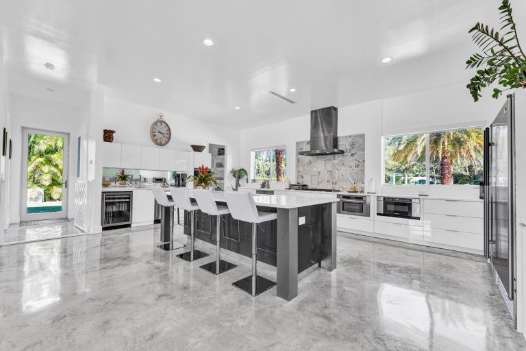 Modern white kitchen with a large island and bar seating