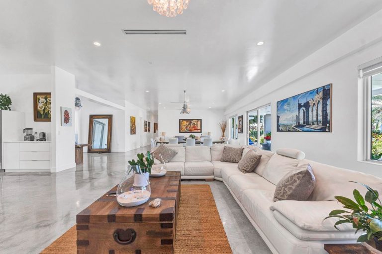 Contemporary lounge with wood coffee table and garden views
